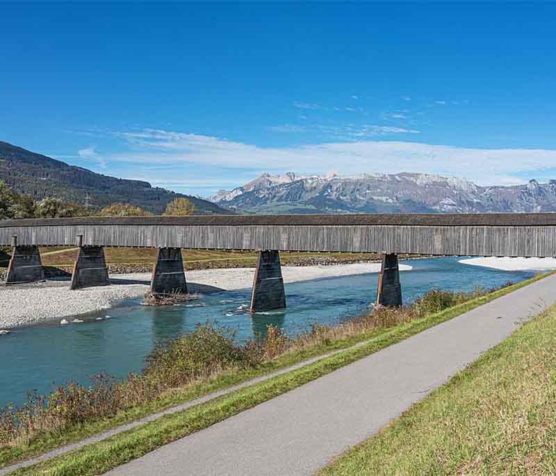 Alte Rheinbrucke (Old Rhine Bridge), a historic wooden bridge over the Rhine River, connecting Liechtenstein and Switzerland.