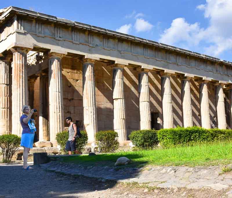 Ancient Agora of Athens, heart of ancient Athens, featuring ruins of buildings, temples, including the Temple of Hephaestus.