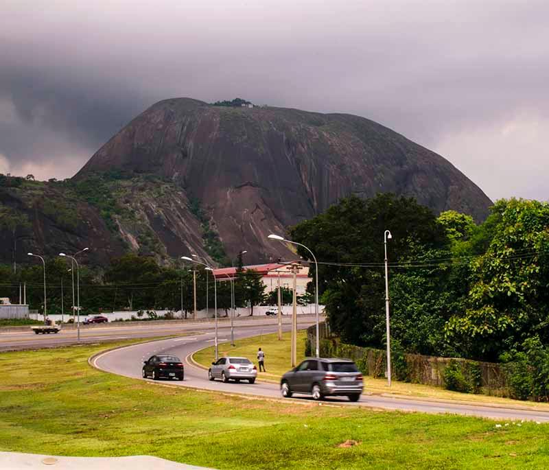 Aso Rock - A prominent rock formation in Abuja, symbolizing the seat of Nigerian power and national identity.