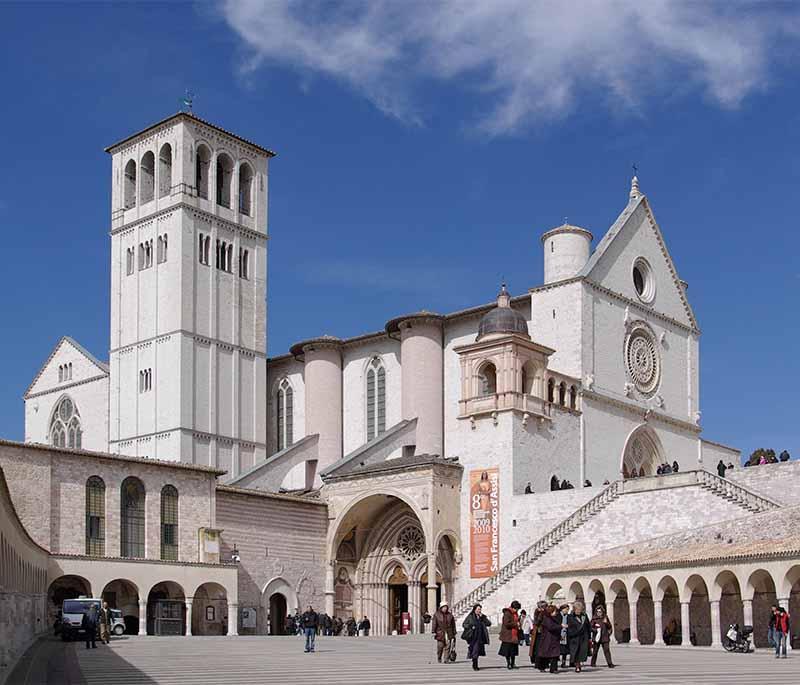 Basilica of San Francesco, Assisi, a major pilgrimage site known for its beautiful frescoes by Giotto and other artists.