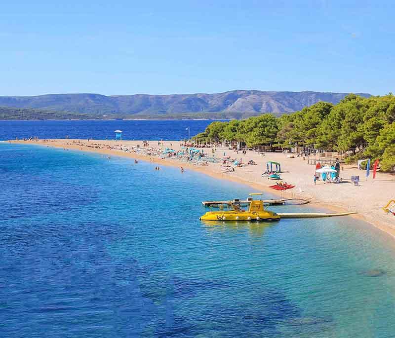 Bol (Brac Island), renowned for its Zlatni Rat beach, charming old town, and excellent windsurfing conditions.