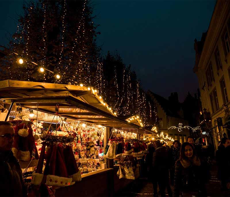 Bruges' Markt Square, featuring the bustling central square with its historic buildings and lively atmosphere.