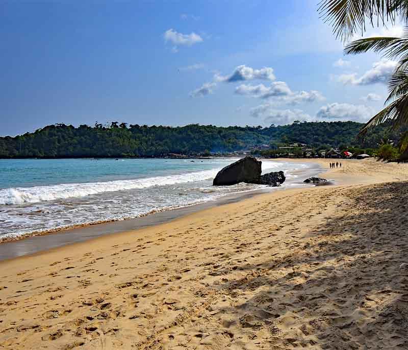 Busua Beach, a beautiful sandy beach known for its surfing, laid-back atmosphere, and beachfront resorts.