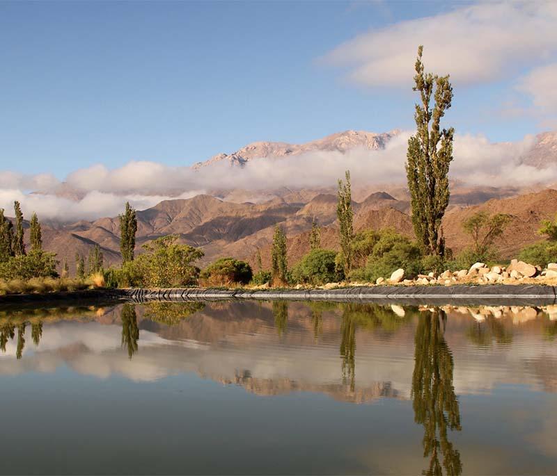 Calchaquí Valleys, Salta: Illustrating rugged landscapes with vineyards and rural settlements, scenic and serene.