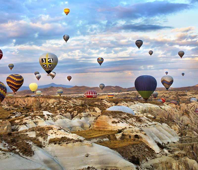 Cappadocia - A region famous for its unique rock formations, ancient cave dwellings, and hot air balloon rides.