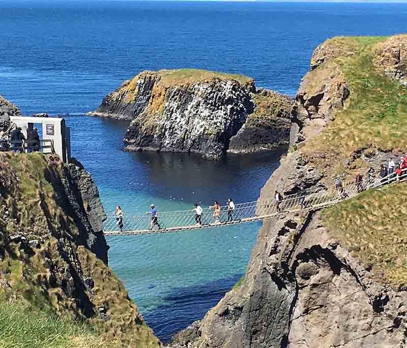 Carrick-a-Rede Rope Bridge, County Antrim, a thrilling rope bridge with stunning coastal views, connecting to a small island.