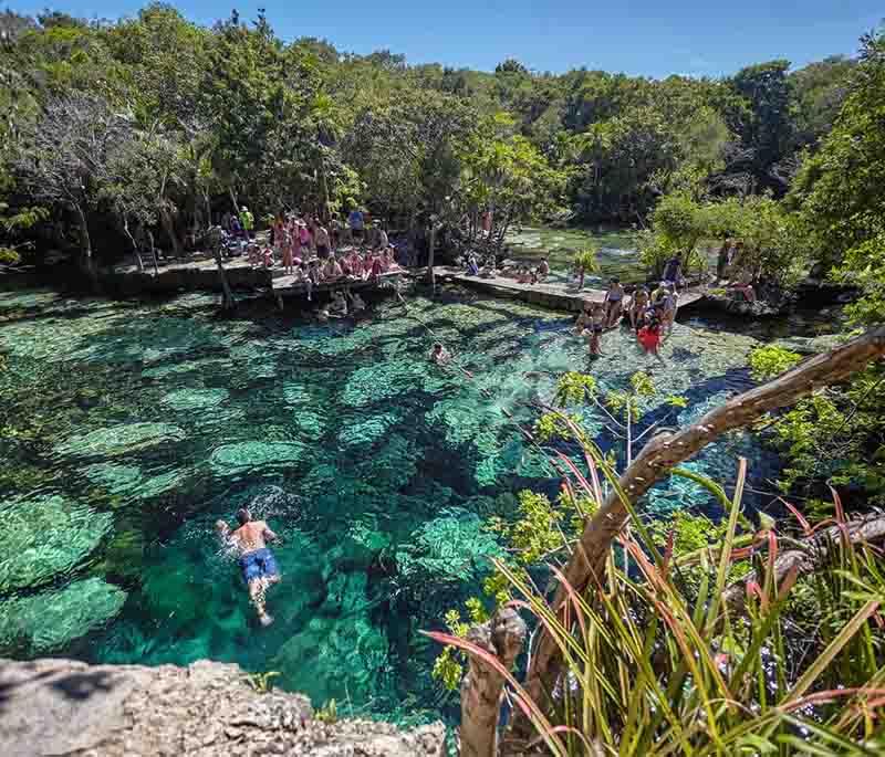 Cenote Azul, Quintana Roo - A beautiful open-air cenote perfect for swimming and snorkeling in its clear blue waters.