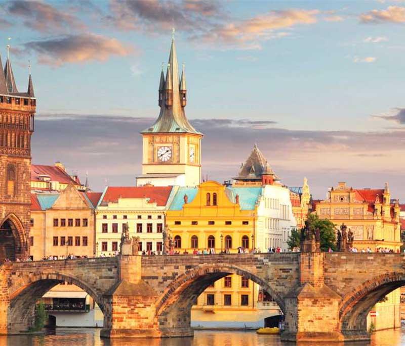 Charles Bridge, Prague, a historic stone bridge adorned with statues, offering views of the Vltava River and the city.