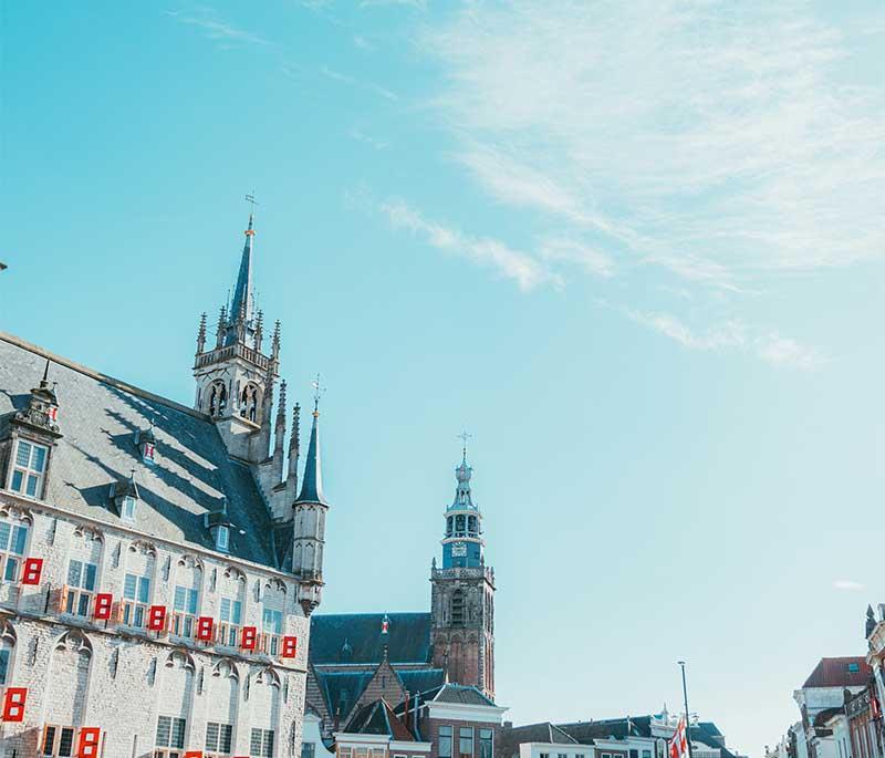 Cheese markets in Alkmaar, Gouda, and Edam featuring colorful stalls, traditional Dutch outfits, and fresh cheeses.