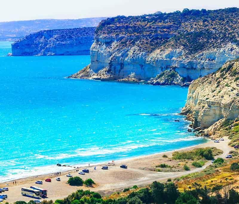 Curium Beach, a beautiful sandy beach located near the Kourion Archaeological Site, popular for swimming and relaxation.