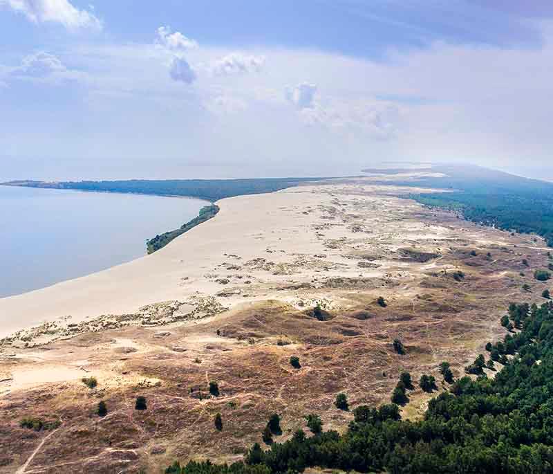 Curonian Spit National Park: UNESCO site with unique sand dunes, forests, and wildlife along the Baltic Sea coast.