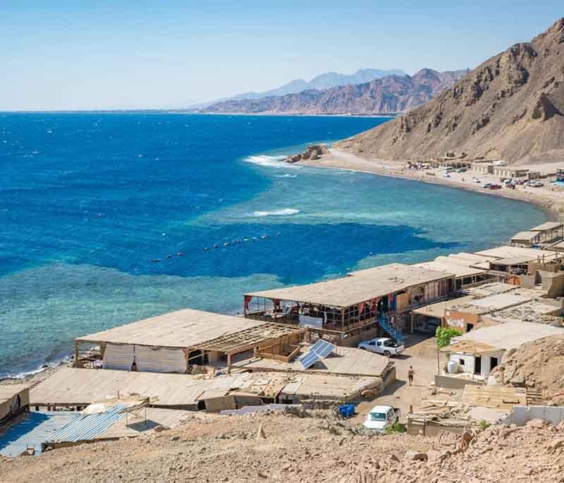 Dahab, a laid-back coastal town on the Red Sea, popular for diving, windsurfing, and its relaxed atmosphere.