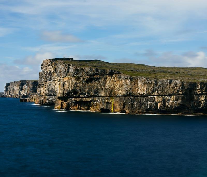 Dun Aengus, Aran Islands, an ancient stone fort perched on a cliff edge, offering dramatic views of the Atlantic.