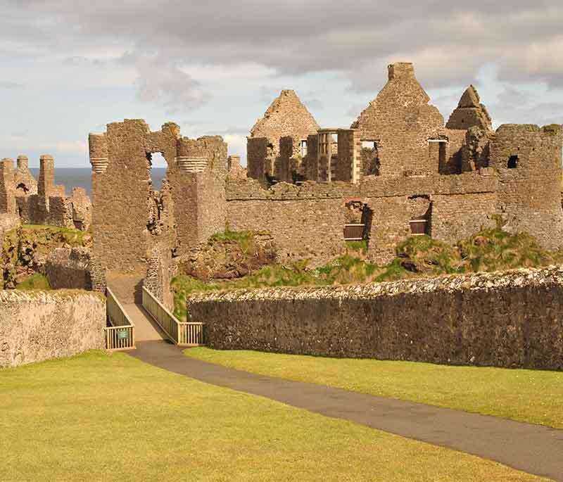 Dunluce Castle, County Antrim, a medieval castle ruin on a dramatic cliff, known for its rich history and stunning location.