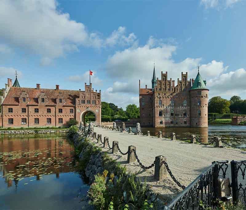 Egeskov Castle, Kværndrup, a well-preserved Renaissance water castle surrounded by beautiful gardens, a maze, and museums.