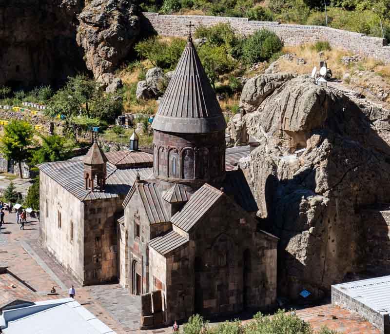 Geghard Monastery, featuring a medieval monastery partially carved out of a mountain with stunning views.