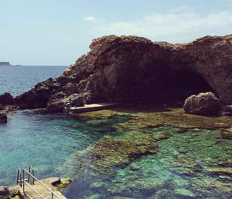 Għar Lapsi is a popular coastal swimming spot known for its clear waters and natural swimming pools.