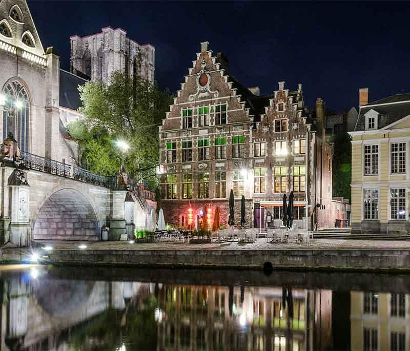 Graslei and Korenlei, Ghent, with picturesque medieval buildings along the river, popular for visitors and locals.