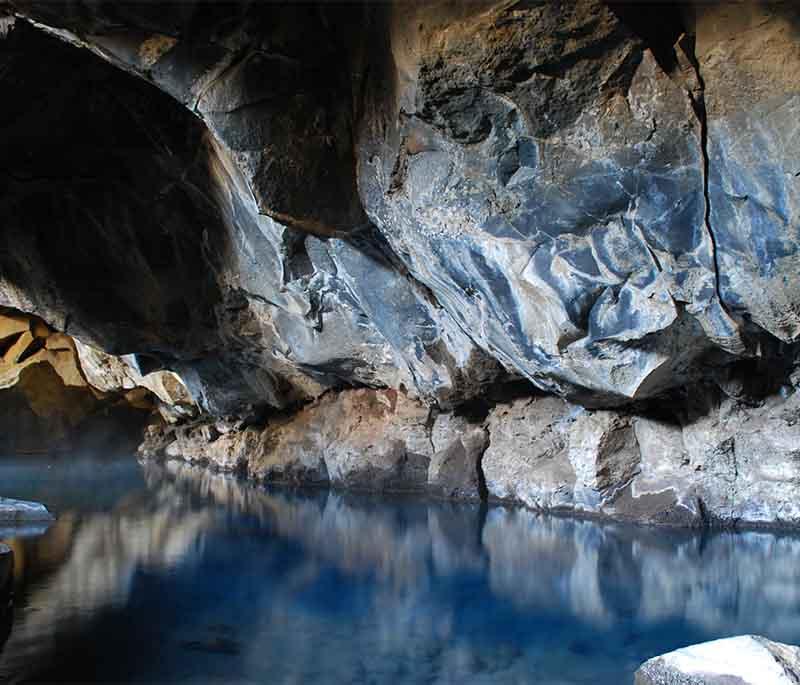 Grjotagja Cave, a small lava cave near beautiful Lake Myvatn, known for its unique geothermal hot springs.