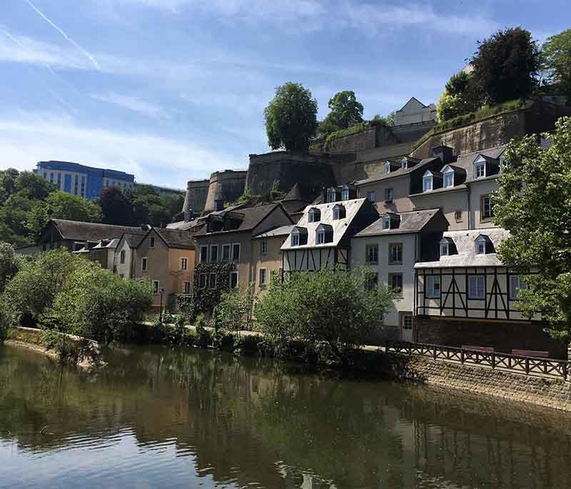 Grund District: A charming area in Luxembourg City with narrow streets, historic buildings, and scenic Alzette River views.