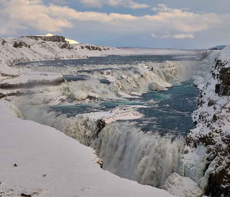 Gullfoss Waterfall, a powerful waterfall on the Hvita River, known for its dramatic two-tiered cascade.