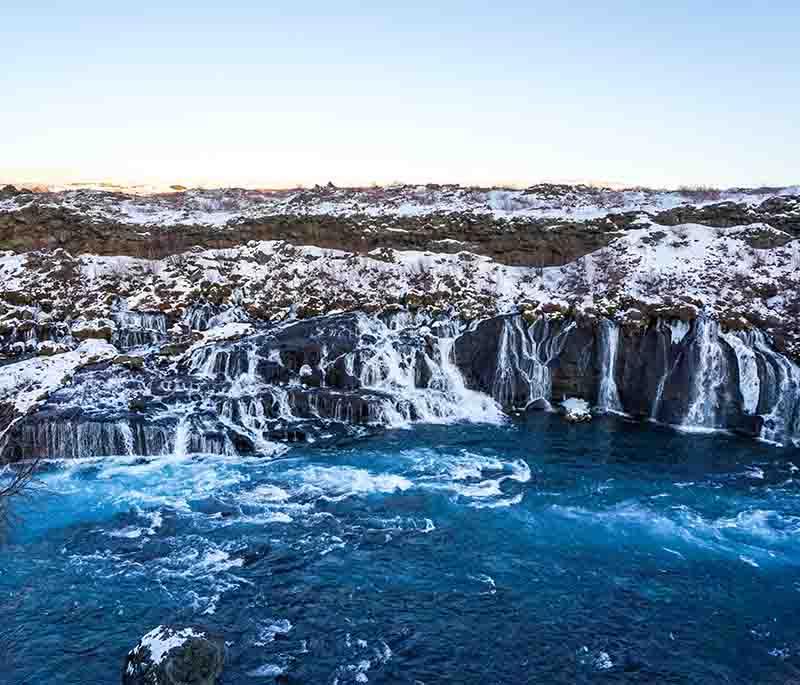 Hraunfossar and Barnafoss Waterfalls, beautiful waterfalls in western Iceland, known for unique formations and scenery.