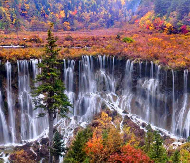 Jiuzhai Valley National Park in Sichuan is famous for its multi-level waterfalls, colorful lakes, and snow-capped peaks.
