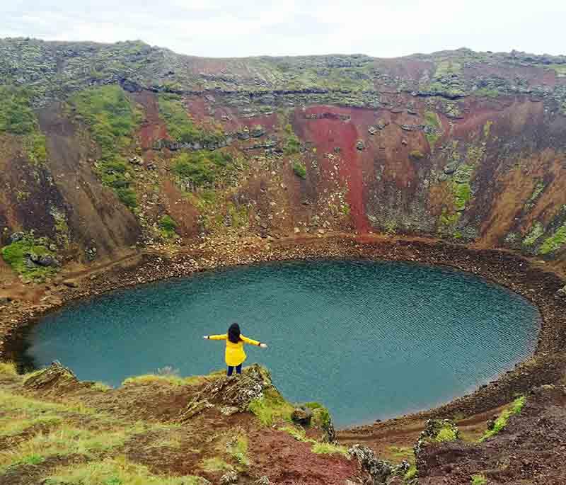 Kerid Crater, a volcanic crater lake in the Golden Circle area, known for its striking blue waters and red volcanic rock.