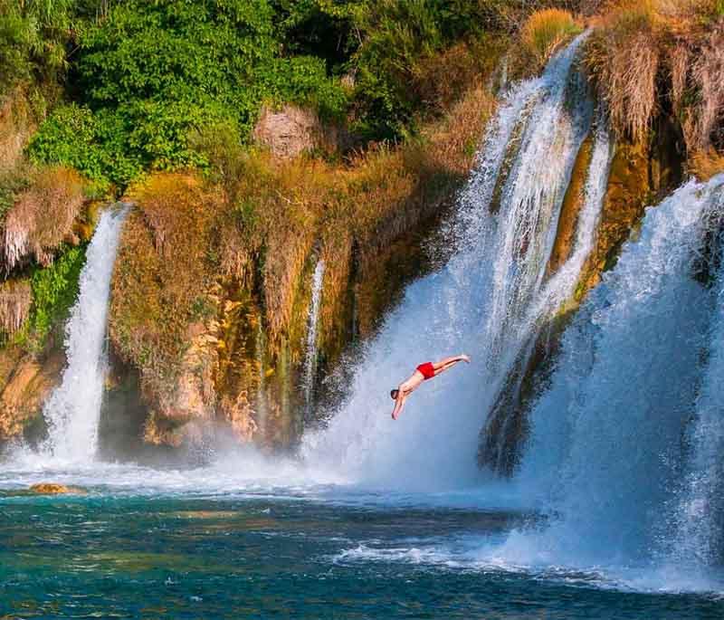 Krka National Park, known for stunning waterfalls, clear lakes, and lush vegetation,offering excellent hiking and sightseeing