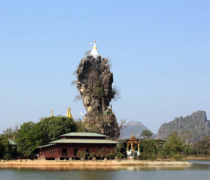Kyauk Ka Lat Pagoda, Hpa An - A unique pagoda perched on top of a limestone pinnacle, surrounded by a lake.