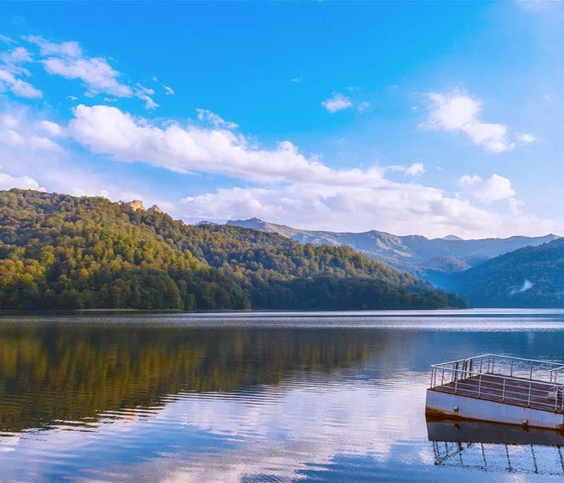 Lake Göygöl, highlighting a serene lake surrounded by dense forests in a picturesque national park setting.