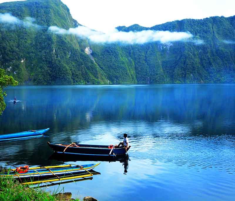 Lake Holon - A crater lake in South Cotabato, surrounded by lush forests and mountains, known for its pristine beauty.