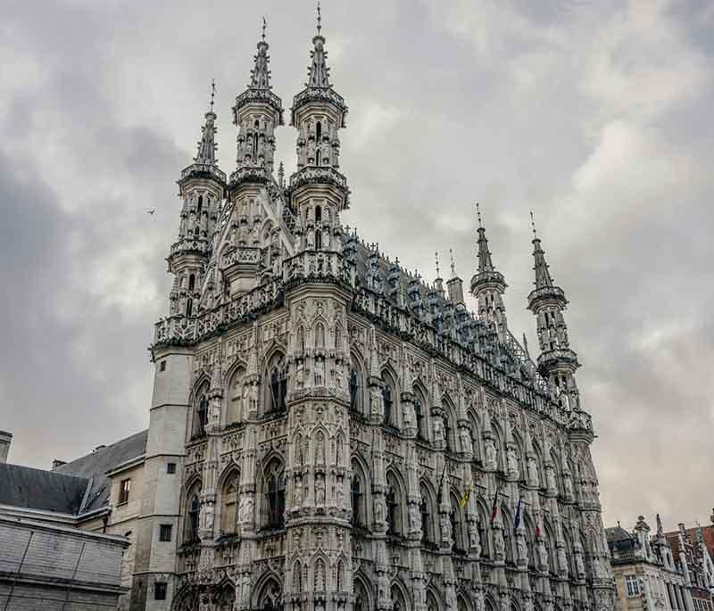 Leuven Town Hall, a stunning Gothic building known for its ornate facade, intricate sculptures, and historical significance.