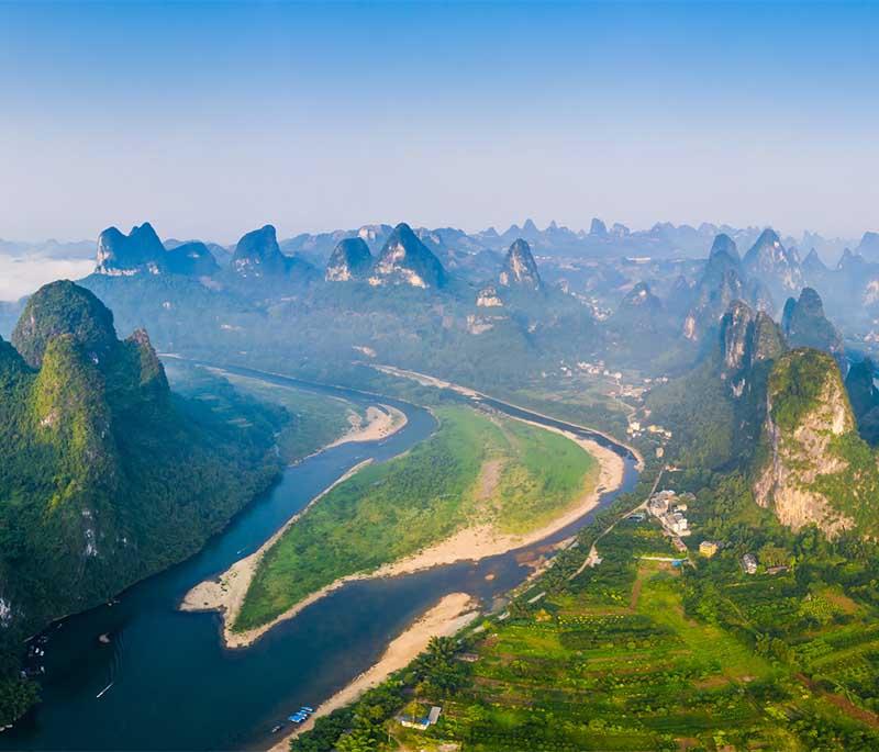 Li River and Karst Mountains in Guilin showcase natural scenery famous for its mist-covered hills and river beauty.