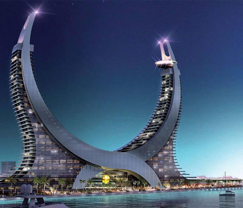 Lusail Marina with yachts docked, boardwalk lit up, and modern skyline reflections shimmering in the water.