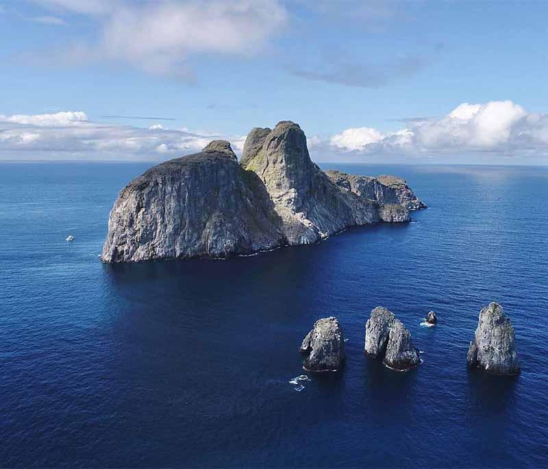 Malpelo Island, a remote island in the Pacific, known for rich marine life, top destination for diving and conservation.