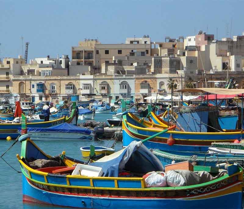 Marsaxlokk, a picturesque fishing village, is known for its colorful boats, vibrant market, and fresh seafood.