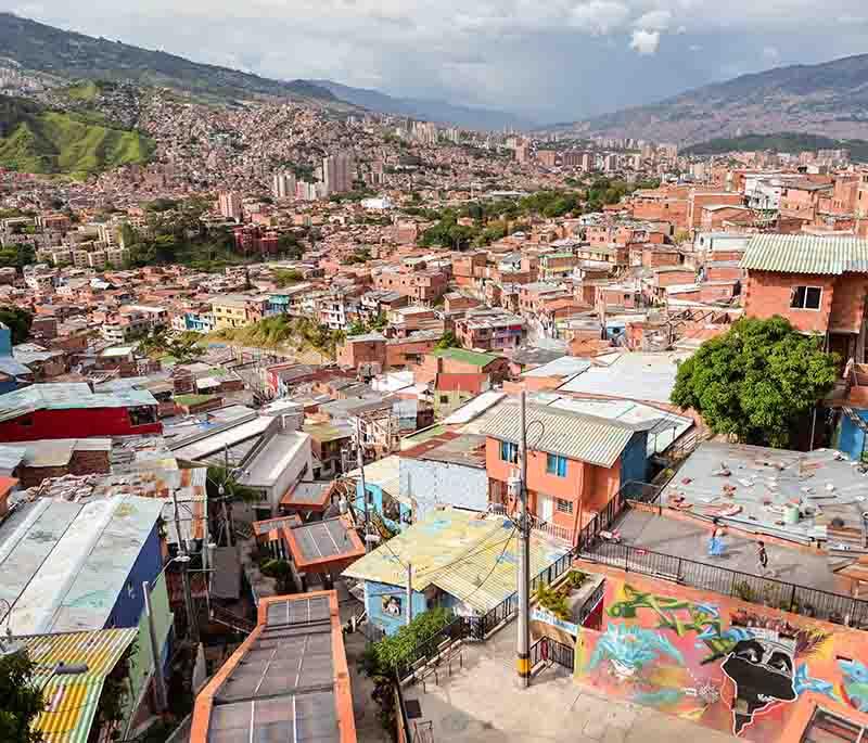 Medellín's Comuna 13, known for its vibrant street art, innovative urban renewal, and rich cultural history.