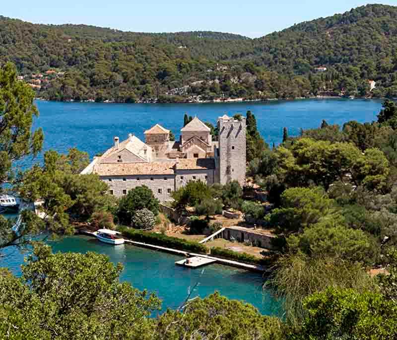 Mljet Island, featuring a national park with pristine lakes, dense forests, and ancient monasteries.