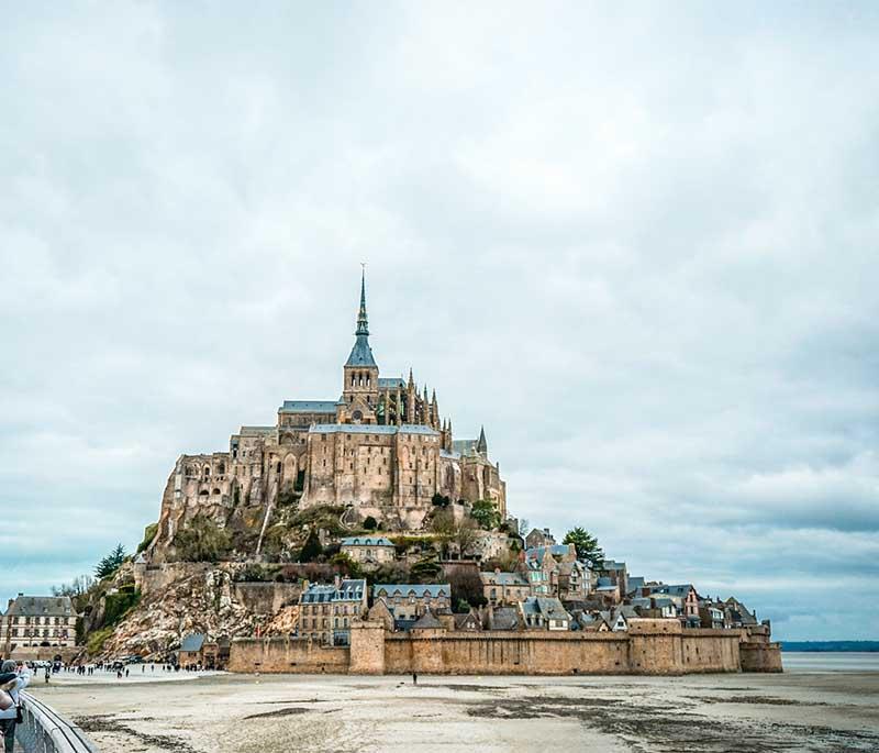 Mont Saint-Michel, Normandy, a stunning island commune topped with a medieval abbey, surrounded by tidal waters.