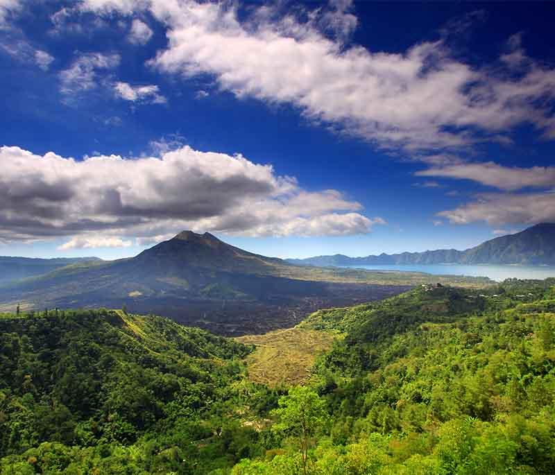 Mount Batur, Bali, an active volcano offering breathtaking sunrise hikes and stunning views of Lake Batur.