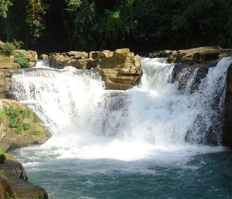 Nafakhum Waterfall, Bandarban, showcasing one of the largest waterfalls in Bangladesh, surrounded by lush greenery.