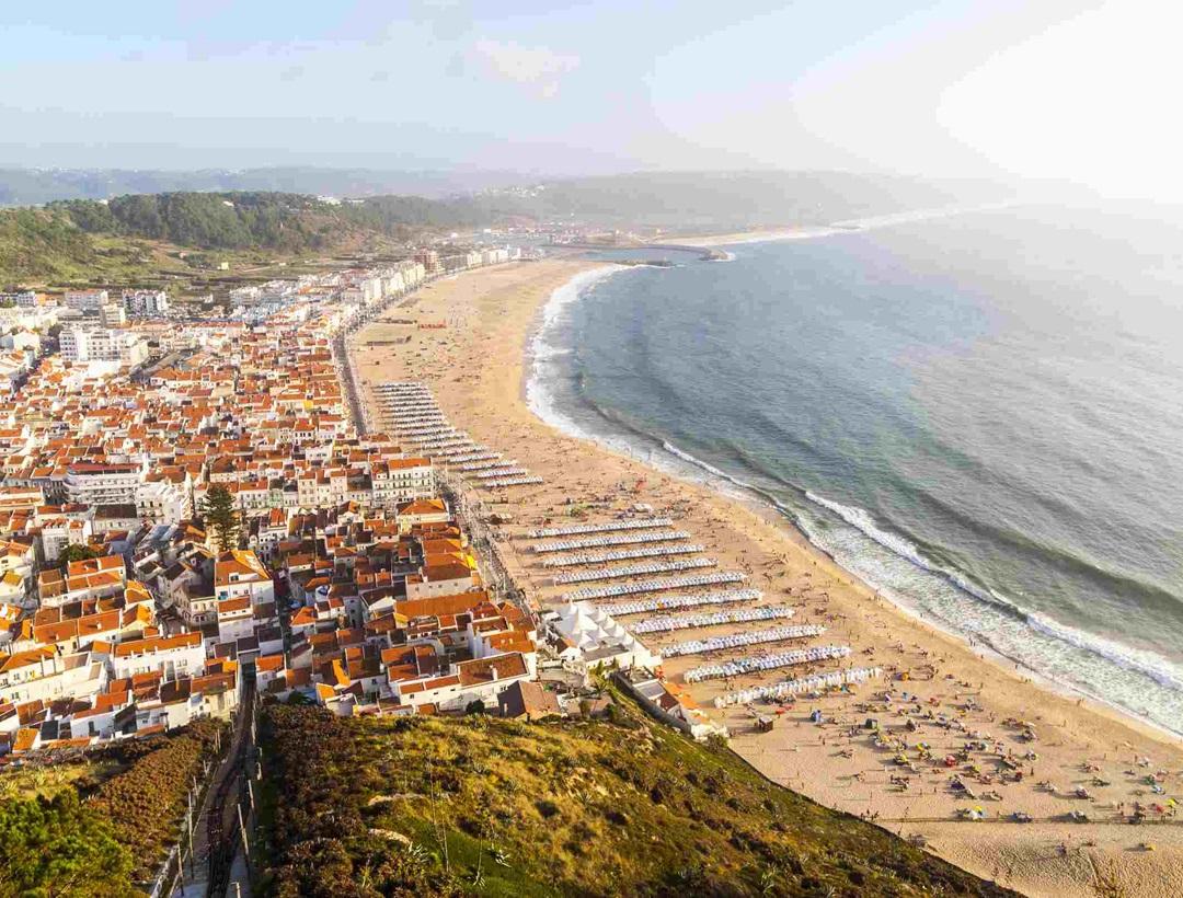 Nazaré - A coastal town famous for massive waves attracting surfers worldwide and traditional fishing culture.