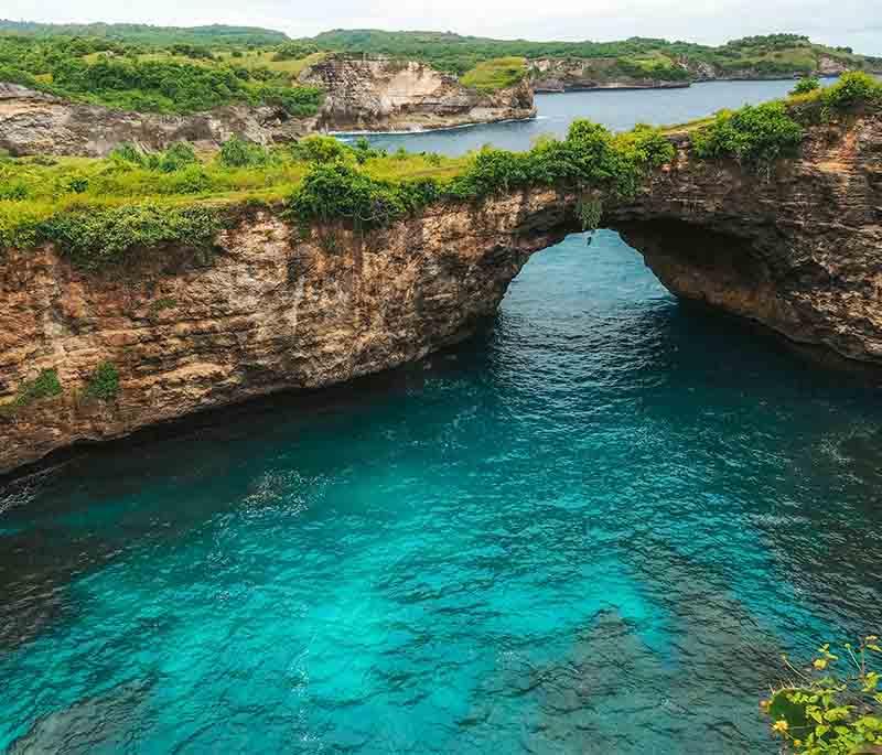 Nusa Penida, Bali, an island known for its dramatic cliffs, stunning beaches, and excellent diving spots.