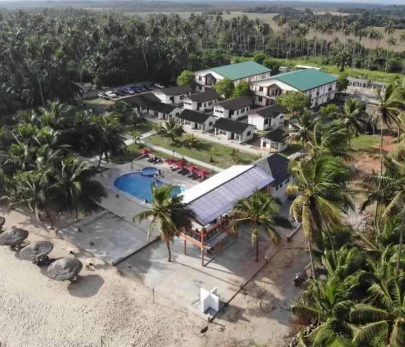 Nzema Manet Beach Resort, a beachfront resort known for its beautiful sandy beach, clear waters, and relaxing atmosphere.