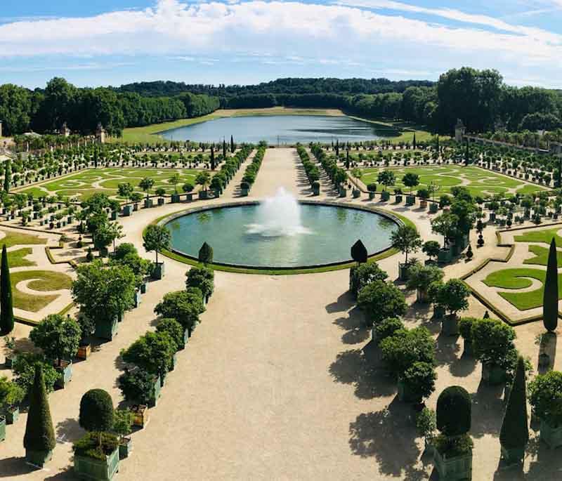 Palace of Versailles, a grand palace known for its opulent architecture, beautiful gardens, and the Hall of Mirrors.