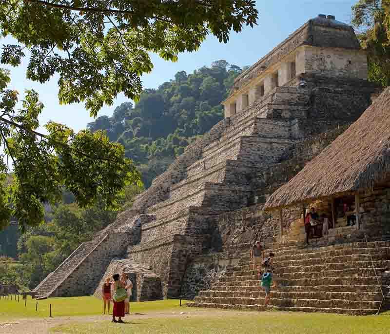 Palenque, Chiapas - Ancient Mayan city-state, architectural beauty, detailed carvings, lush jungle backdrop.