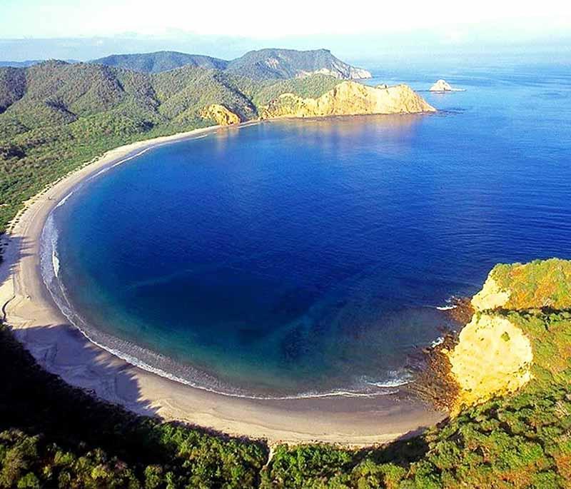 Parque Nacional Machalilla, a coastal park with diverse ecosystems, including beaches, dry forests, and archaeological sites.