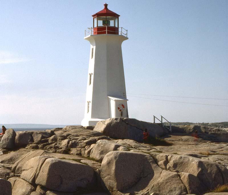 Peggy's Cove in Nova Scotia is iconic for its picturesque lighthouse set against rugged Atlantic coastline.