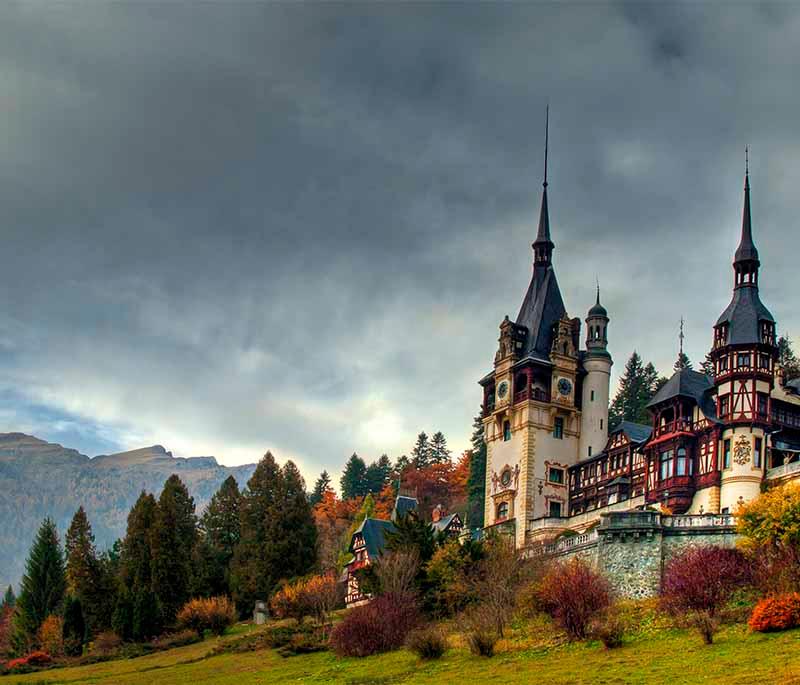 Peleș Castle - Stunning Neo-Renaissance royal palace in Sinaia, surrounded by Carpathian mountain scenery.